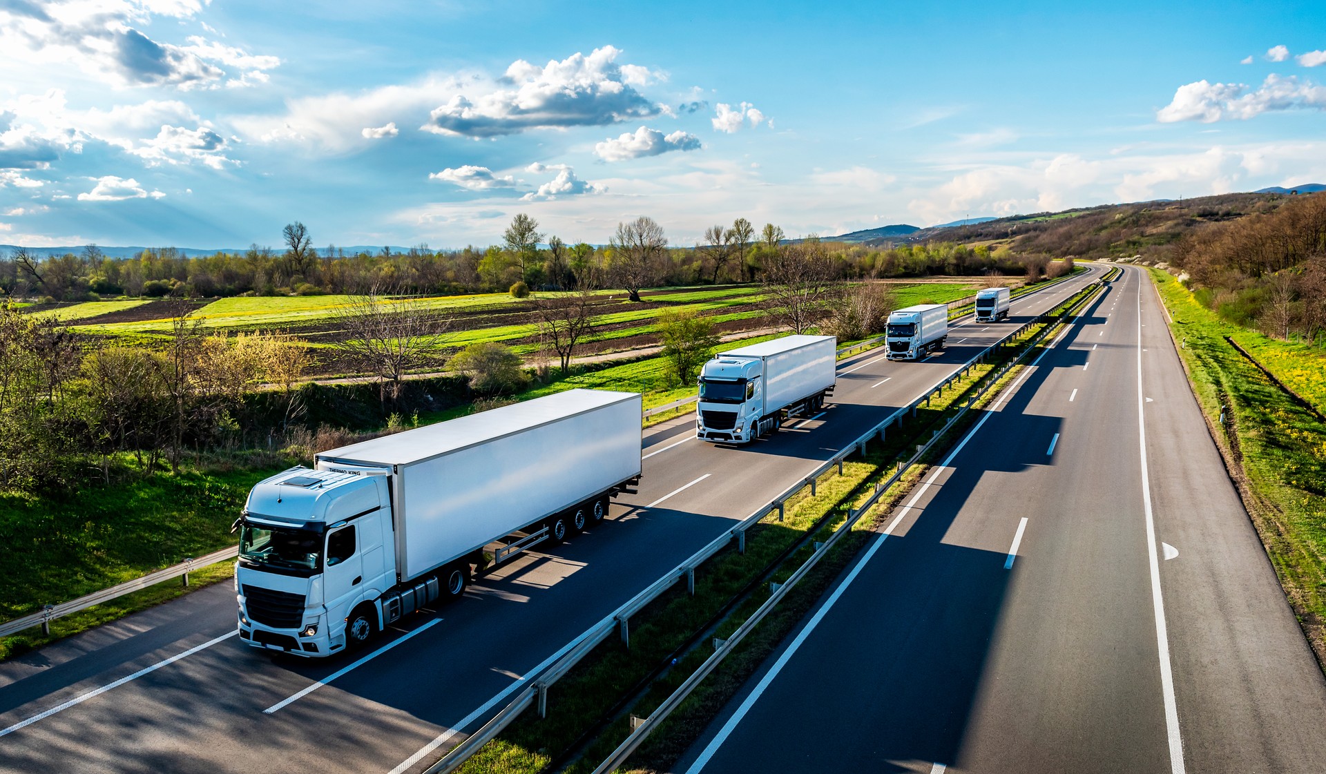 White Trucks with containers on highway